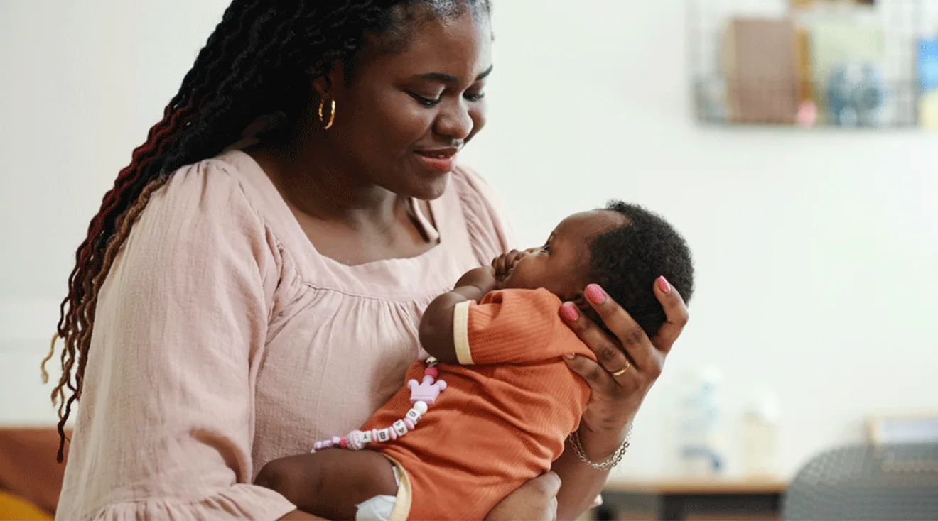 mom holding sleeping baby