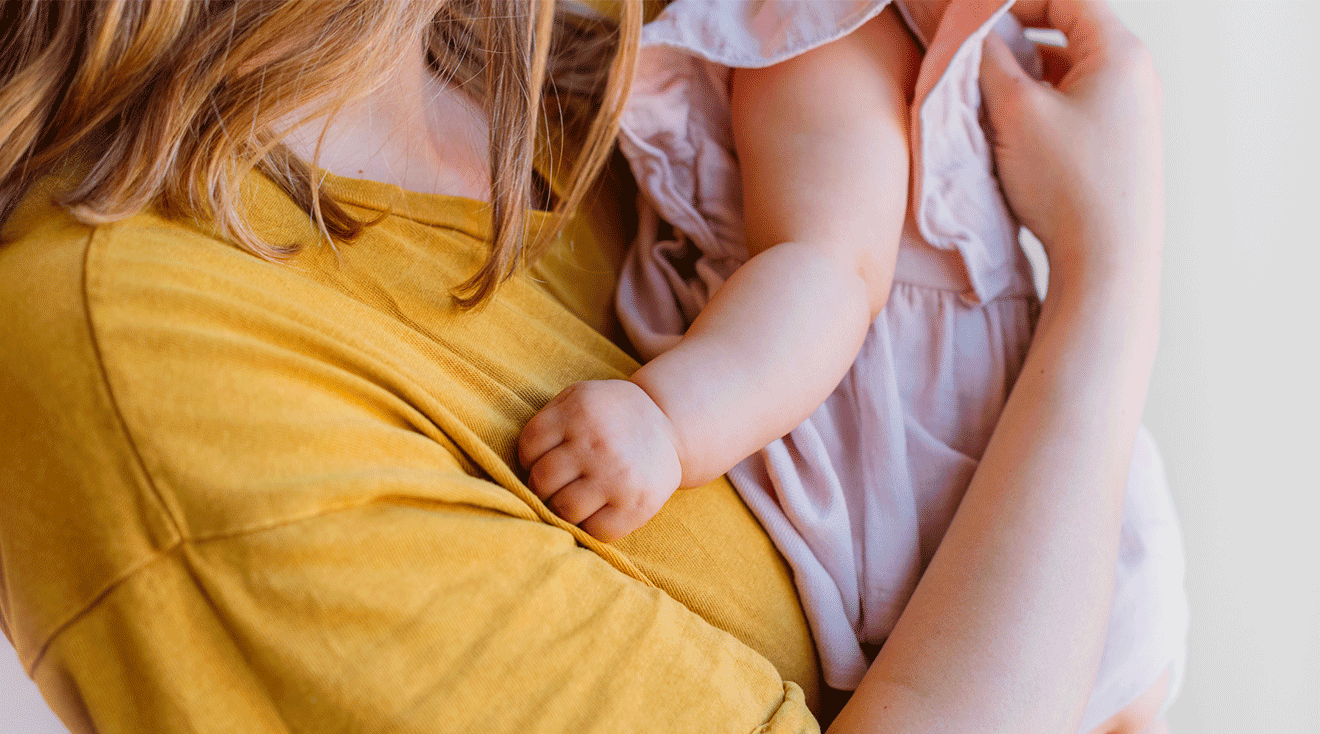 close up of mother holding baby