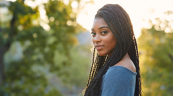 Smiling woman wearing her hair in braided twists. 