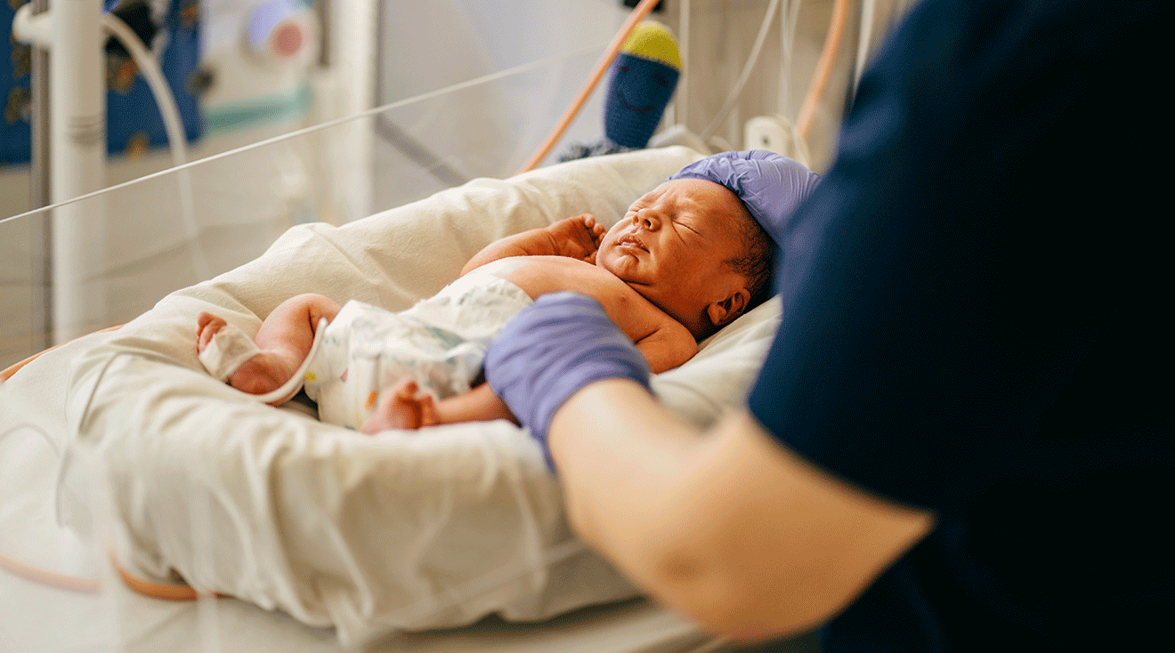 nurse taking care of premature baby in NICU