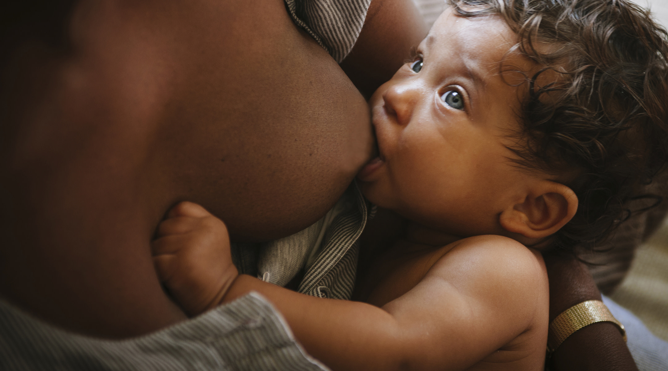 a slightly older baby breastfeeding 