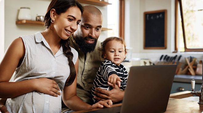 pregnant mom with partner and toddler shopping on laptop
