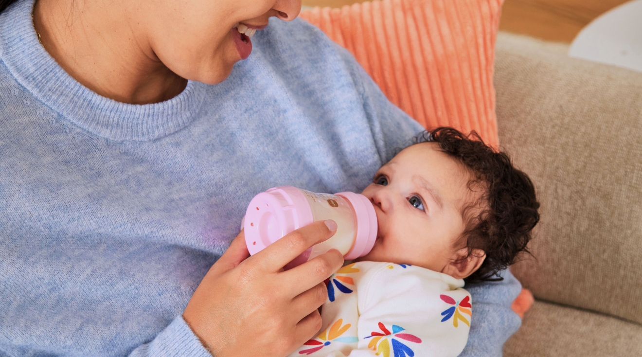 mom feeding baby with mam baby bottle