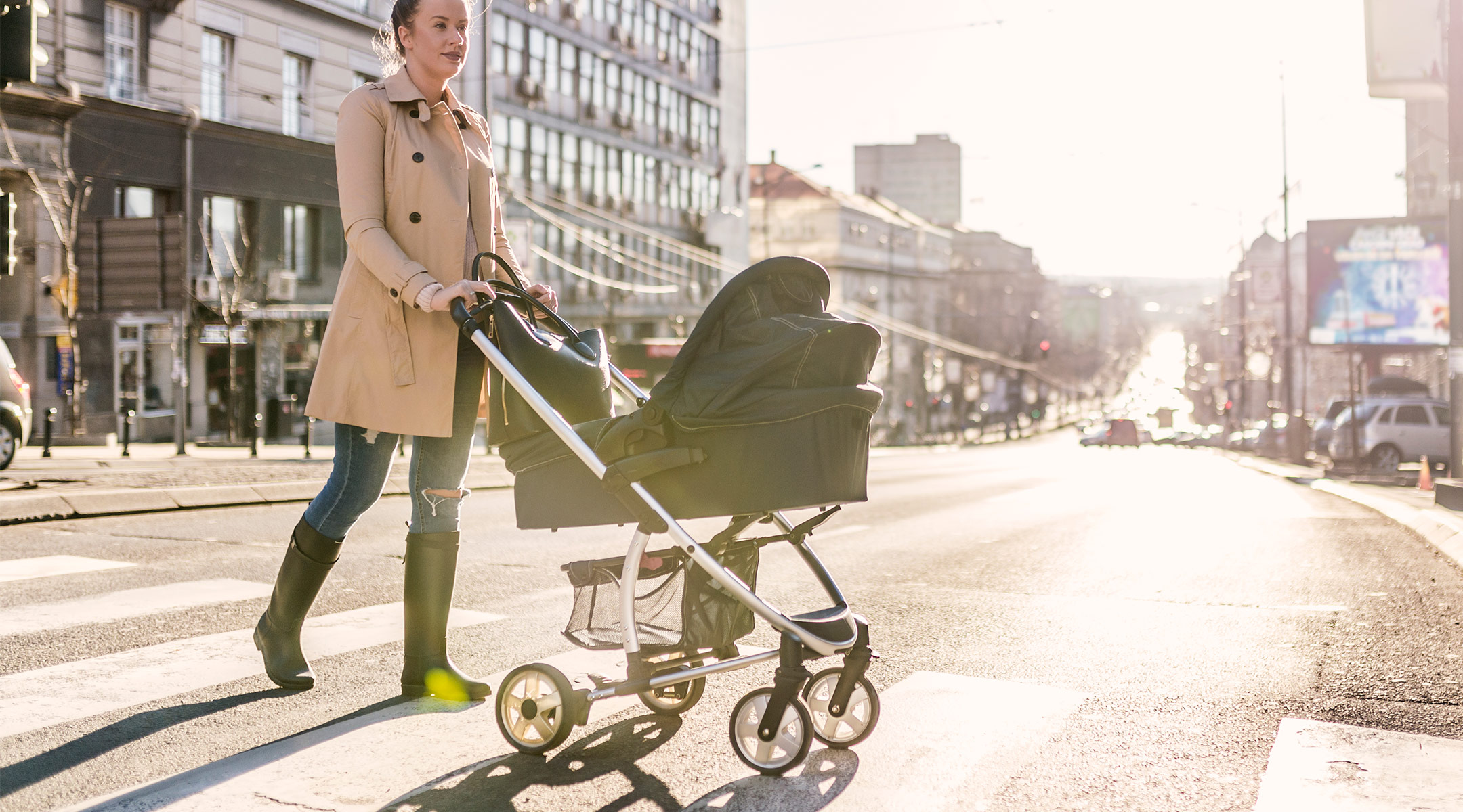 mom pushing stroller in a city setting