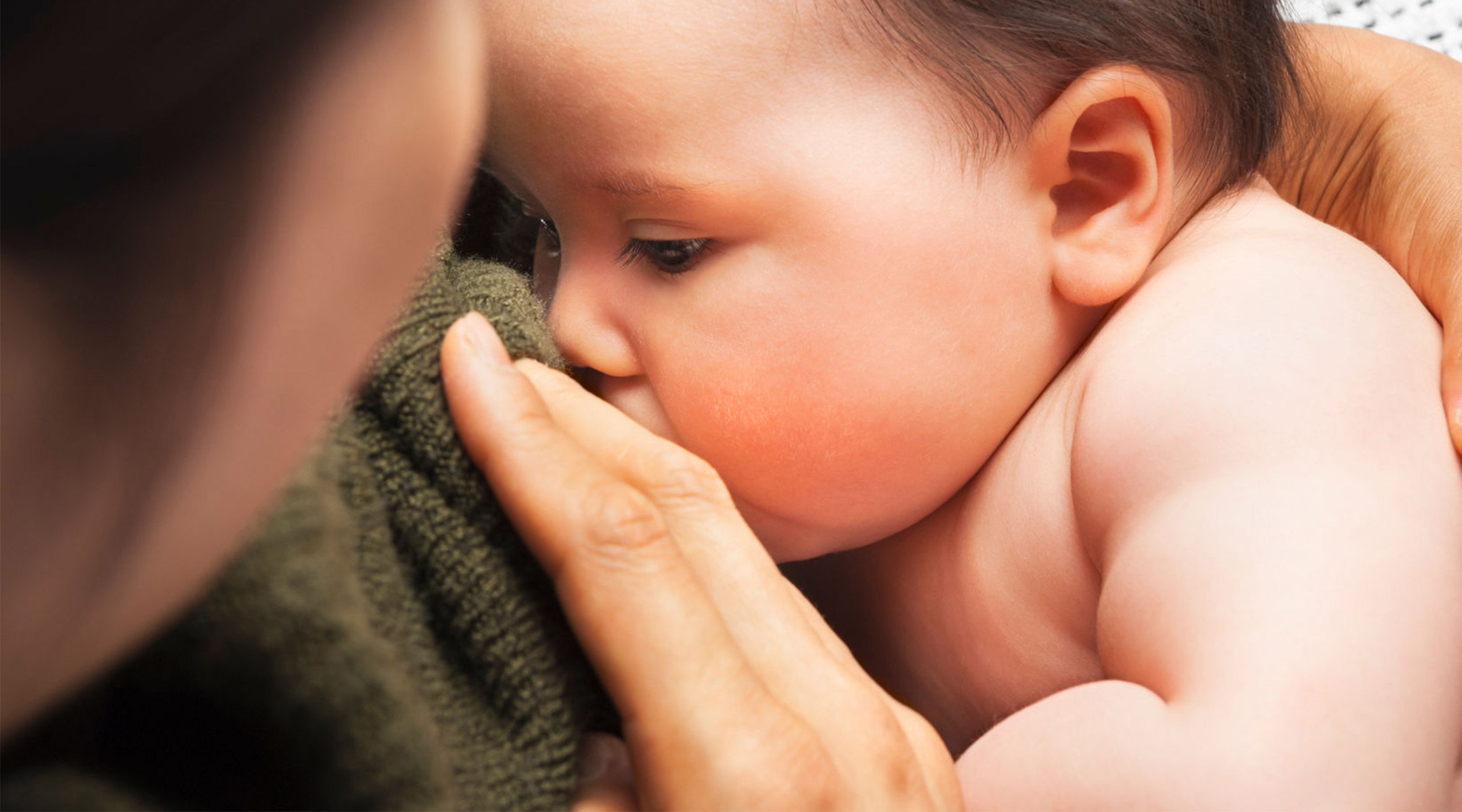 close up of mom breastfeeding her baby