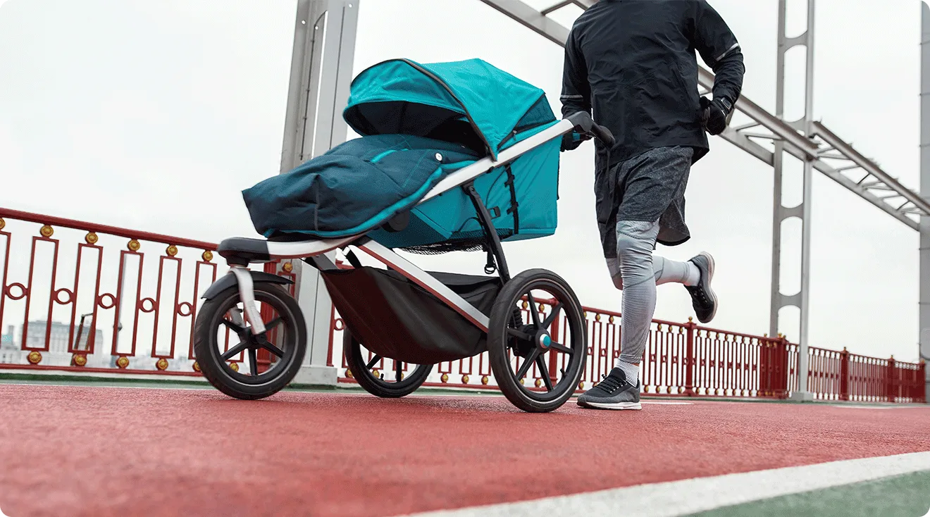 dad running with baby stroller