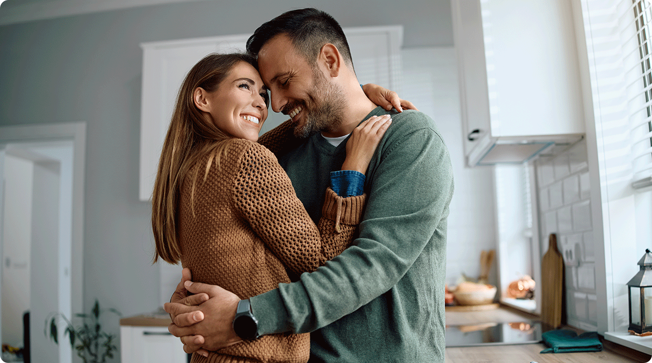 happy couple embracing at home