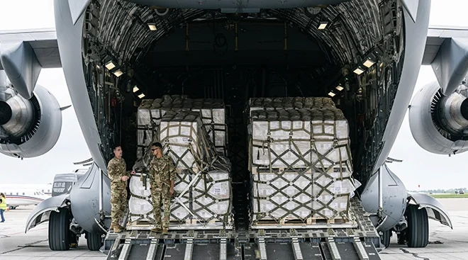 Airmen standing in the cargo bay of a U.S. Air Force C-17 carrying 78,000 lbs of Infant formula from Europe at Indianapolis Airport on May 22, 2022