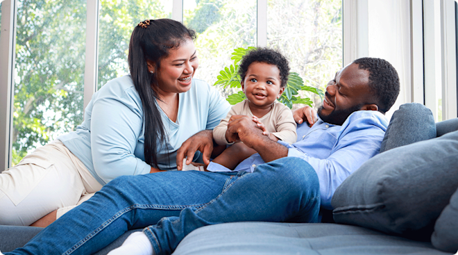 happy mom and dad with toddler at home