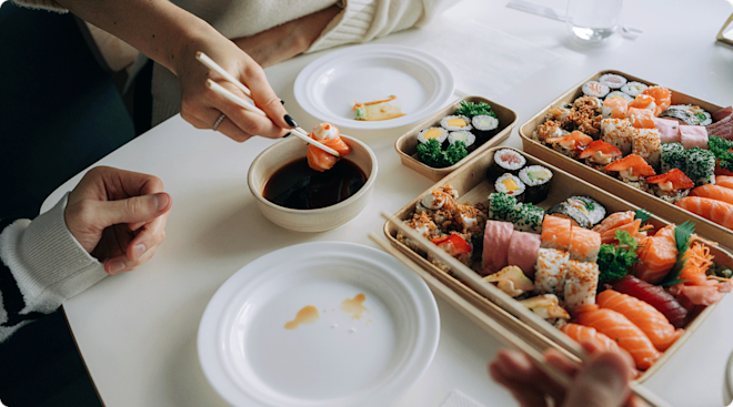 close up of people eating sushi