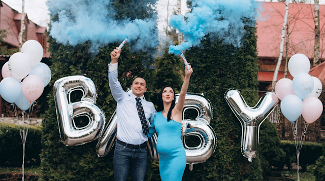 pregnant couple doing a gender reveal for their baby