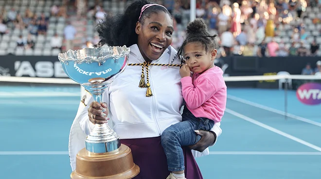 Serena Williams holding trophy and daughter at the Auckland Classic tennis tournament