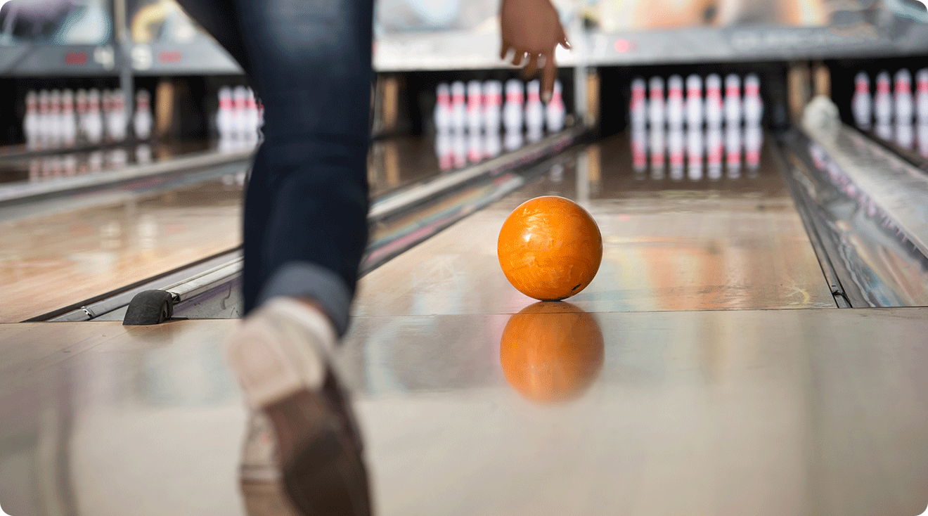 close up of woman bowling in bowling alley