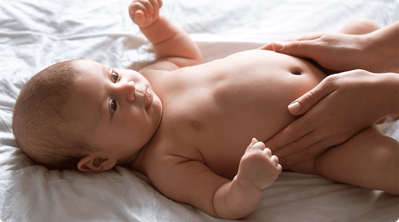 mom caring for newborn baby skin after bath at home