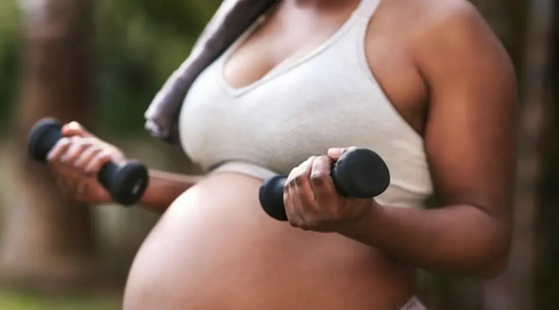 Pregnant woman practicing prenatal yoga on exercise ball for maternal  health and wellness