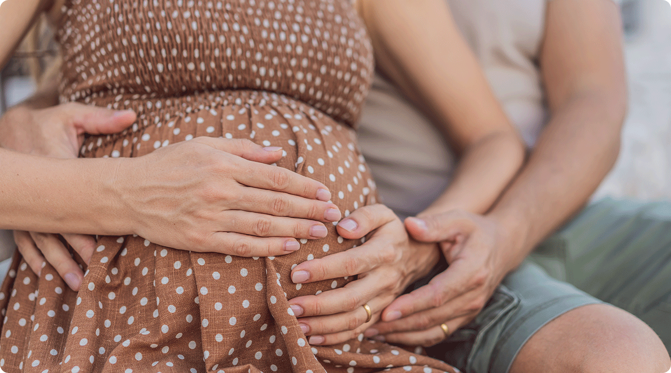 pregnant couple embracing