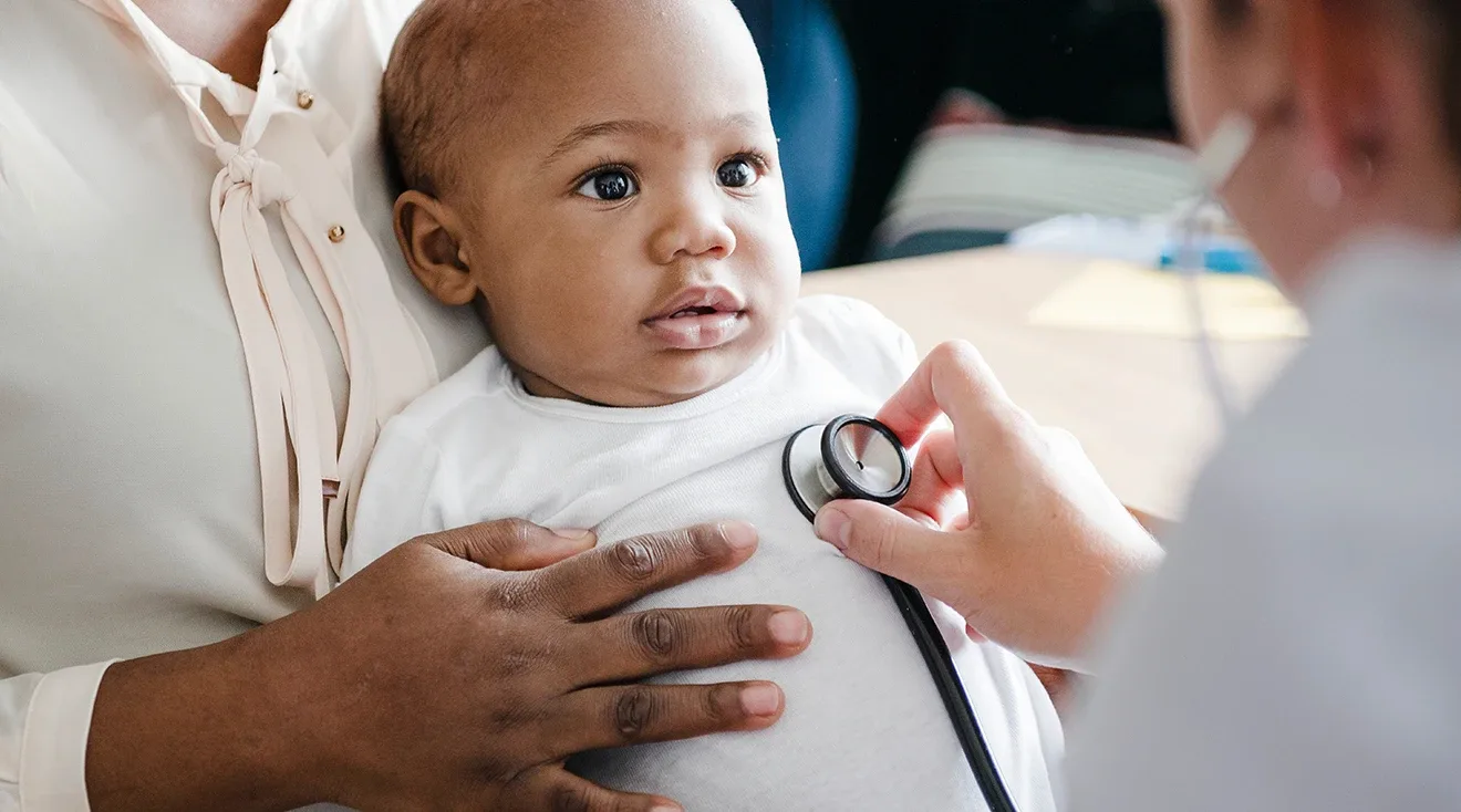 doctor examining 6 month old baby