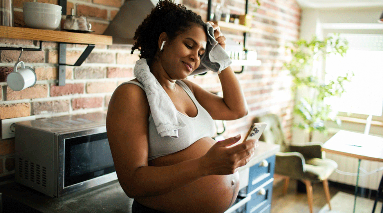 pregnant woman sweating after exercising at home