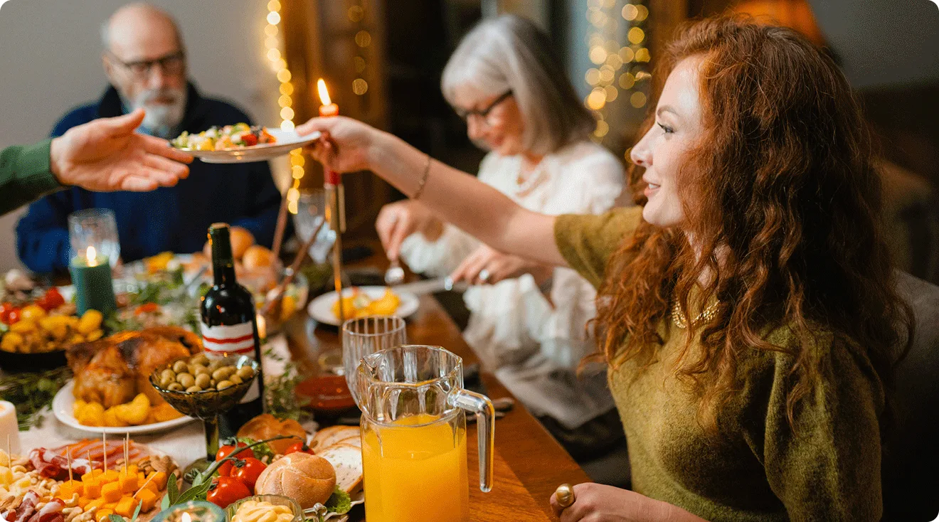 young woman sitting at dinner table during holiday family gathering