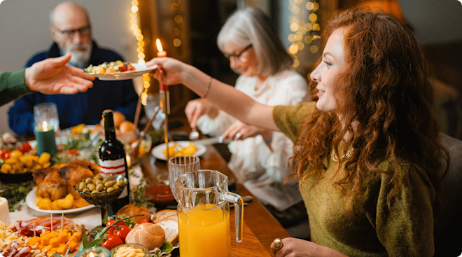 young woman sitting at dinner table during holiday family gathering
