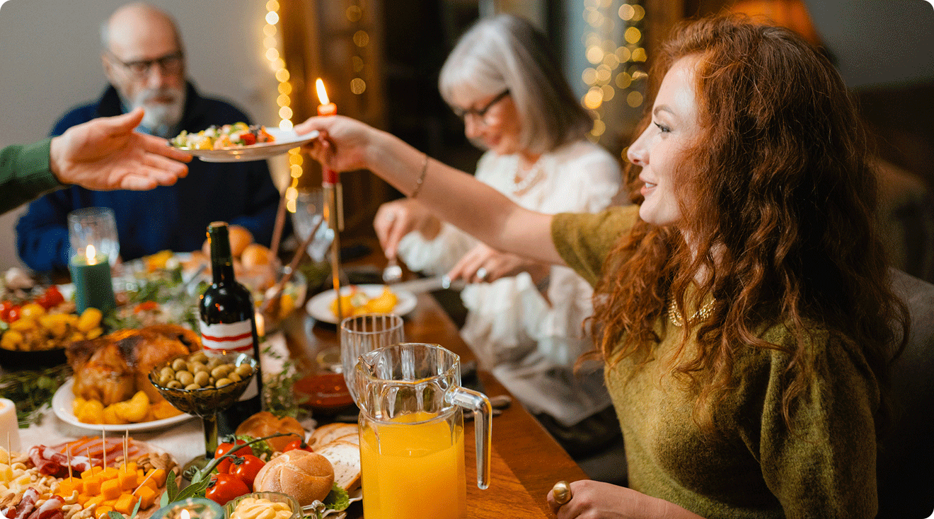 young woman sitting at dinner table during holiday family gathering