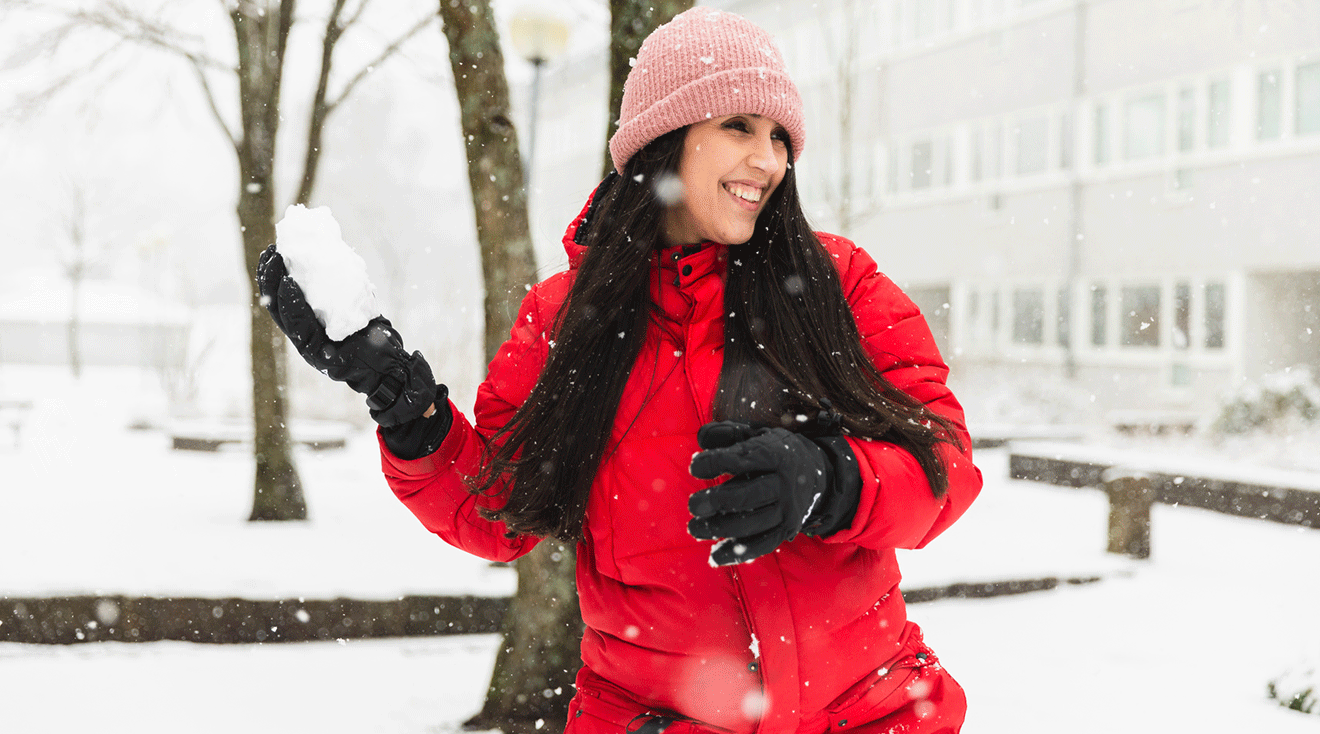 pregnant woman having fun in the snow during winter