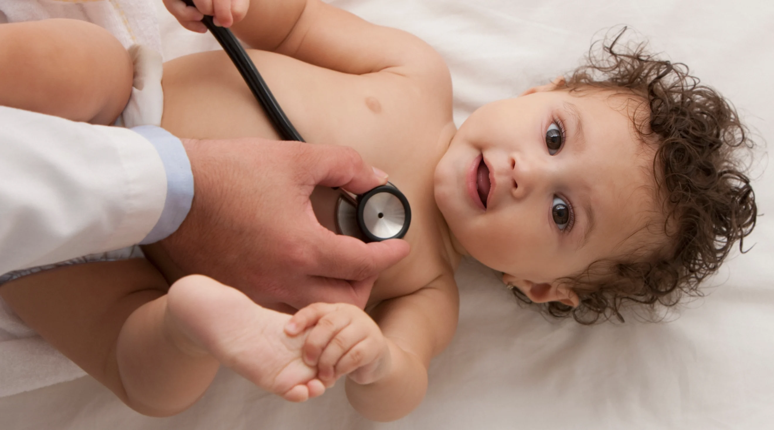 baby being examined by doctor with stethescope