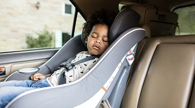 baby sleeping in car seat in car