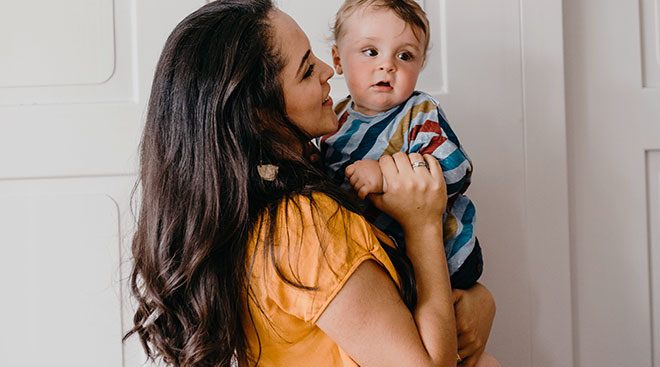 mom holding and talking to her baby