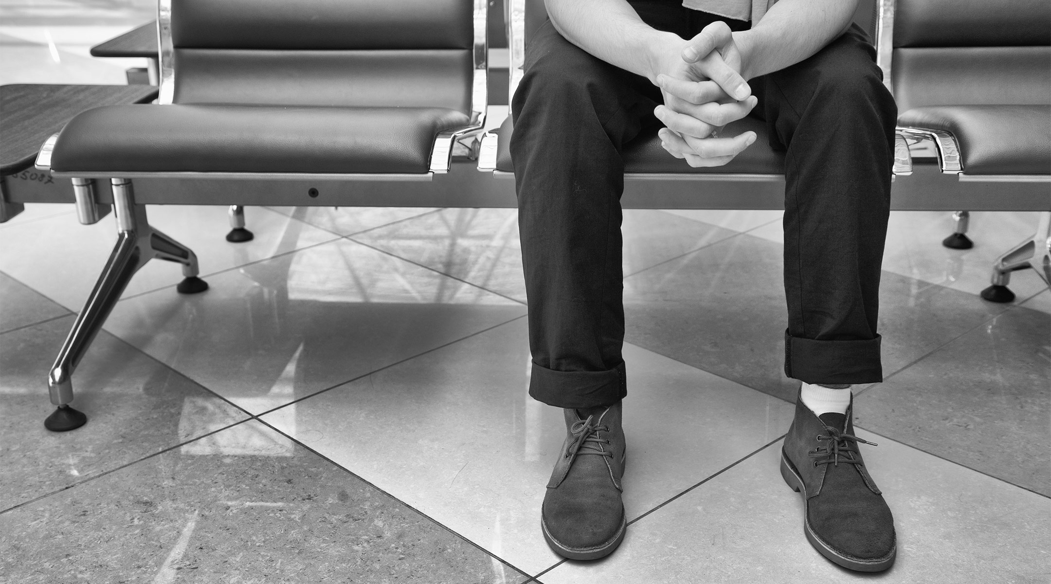 view of man's feet as he waits in the hospital