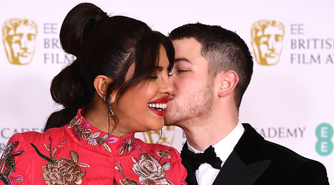 Nick Jonas and Priyanka Chopra Jonas embracing on red carpet