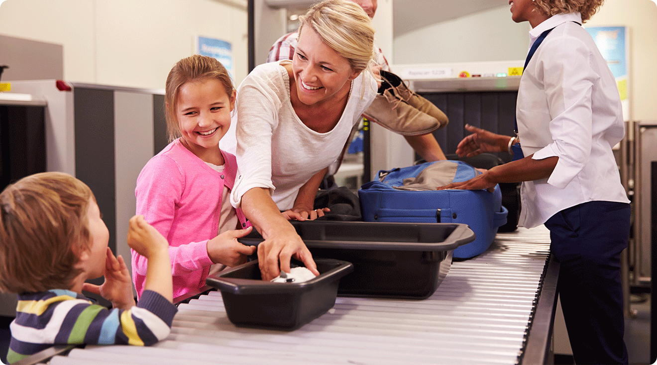 family with 2 young children going through airport security