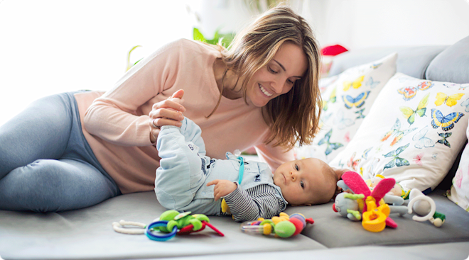 mom playing with newborn baby toys