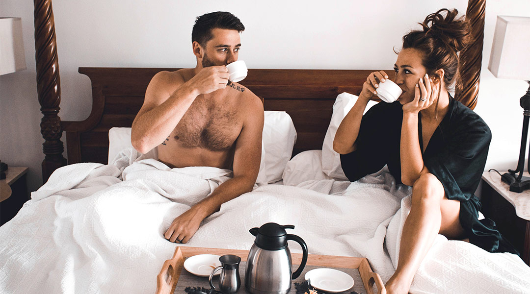 couple having coffee in bed together