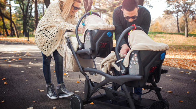 young family with double stroller in the park. 