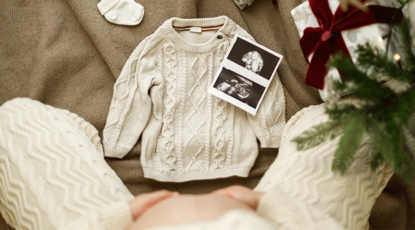 christmas pregnancy announcement with baby sweater and ultrasound