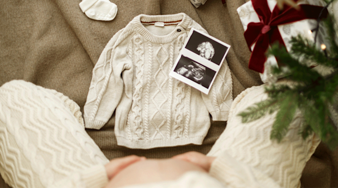 christmas pregnancy announcement with baby sweater and ultrasound