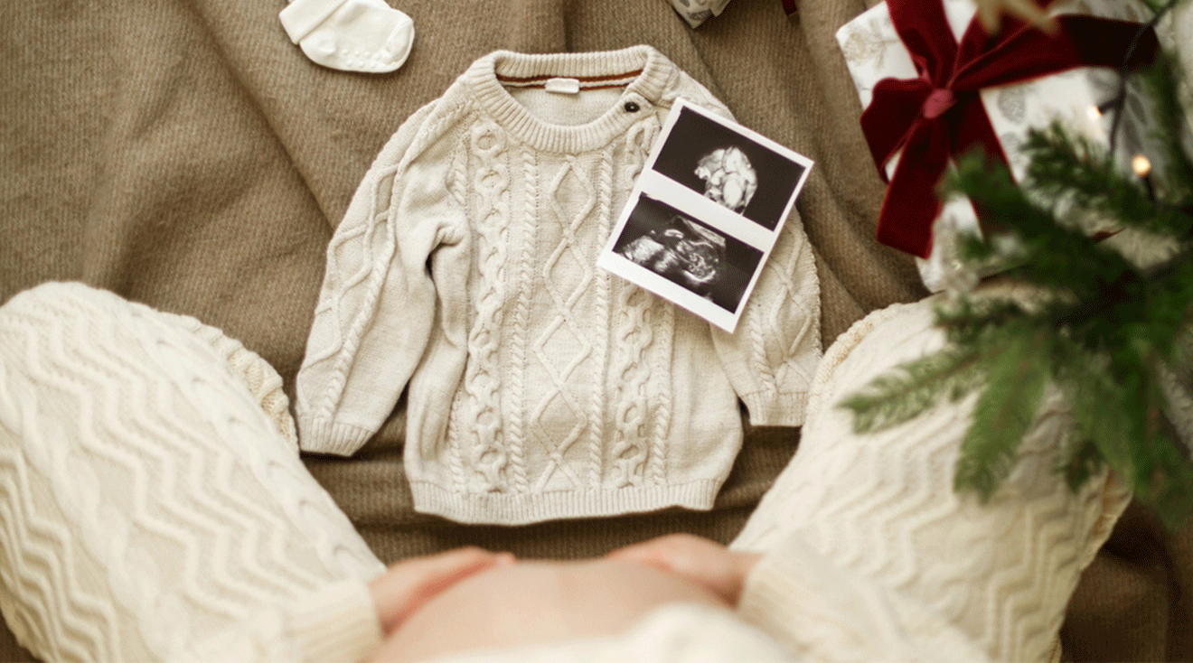 christmas pregnancy announcement with baby sweater and ultrasound