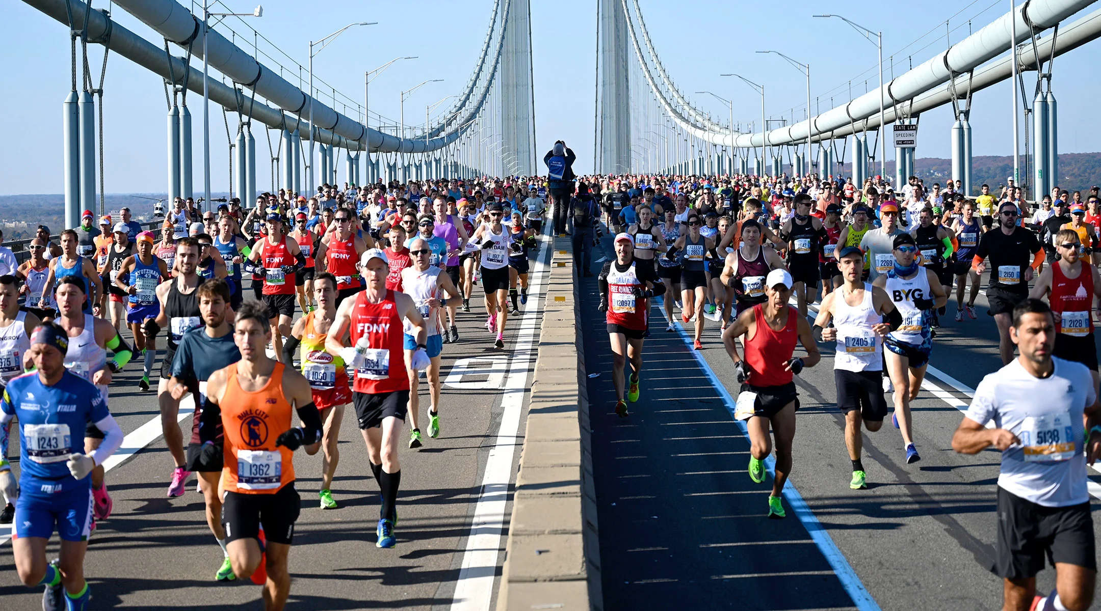 many runners at the start of the new york marathon on the verrazano bridge