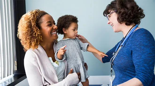 Toddler with her mom at the doctor's office.