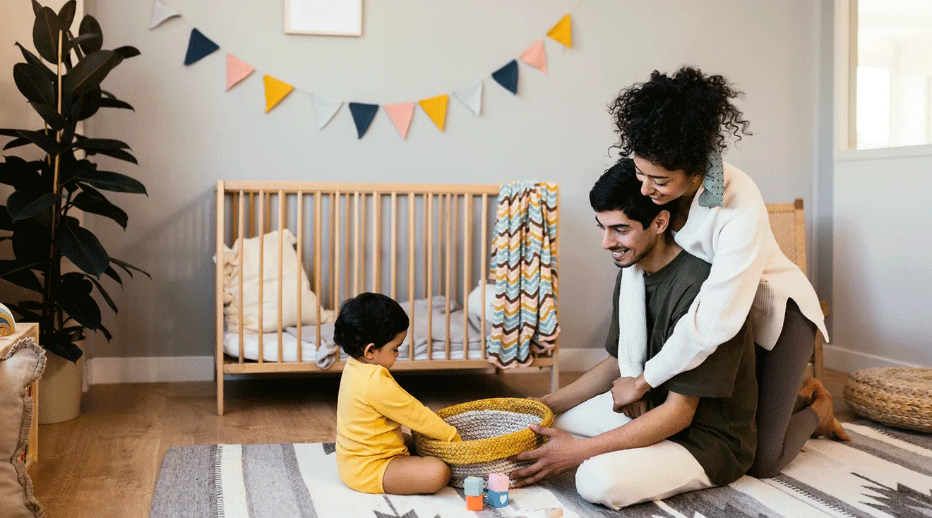 parents sitting with baby during play time in nursery