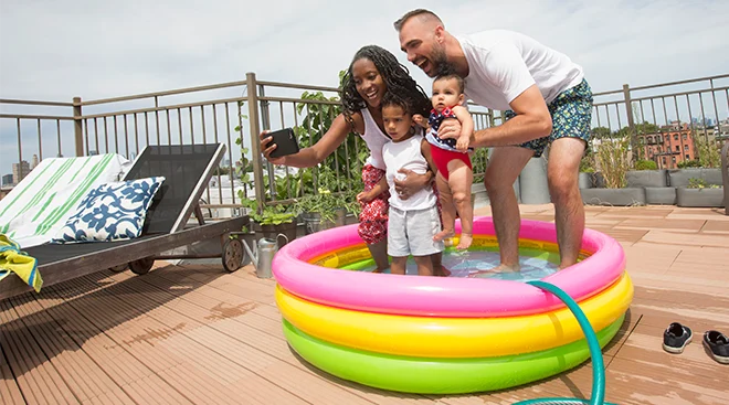 family having fun and taking a selfie in their outdoor kiddy pool