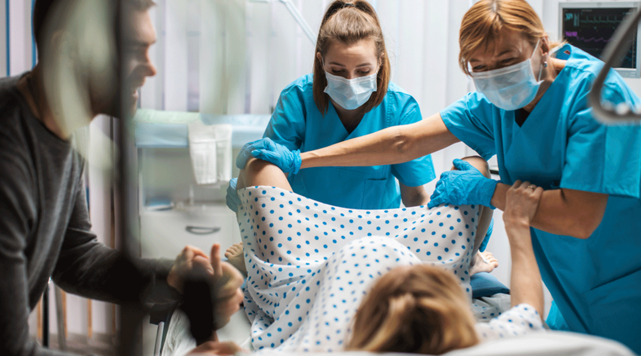 doctors helping woman during labor and delivery