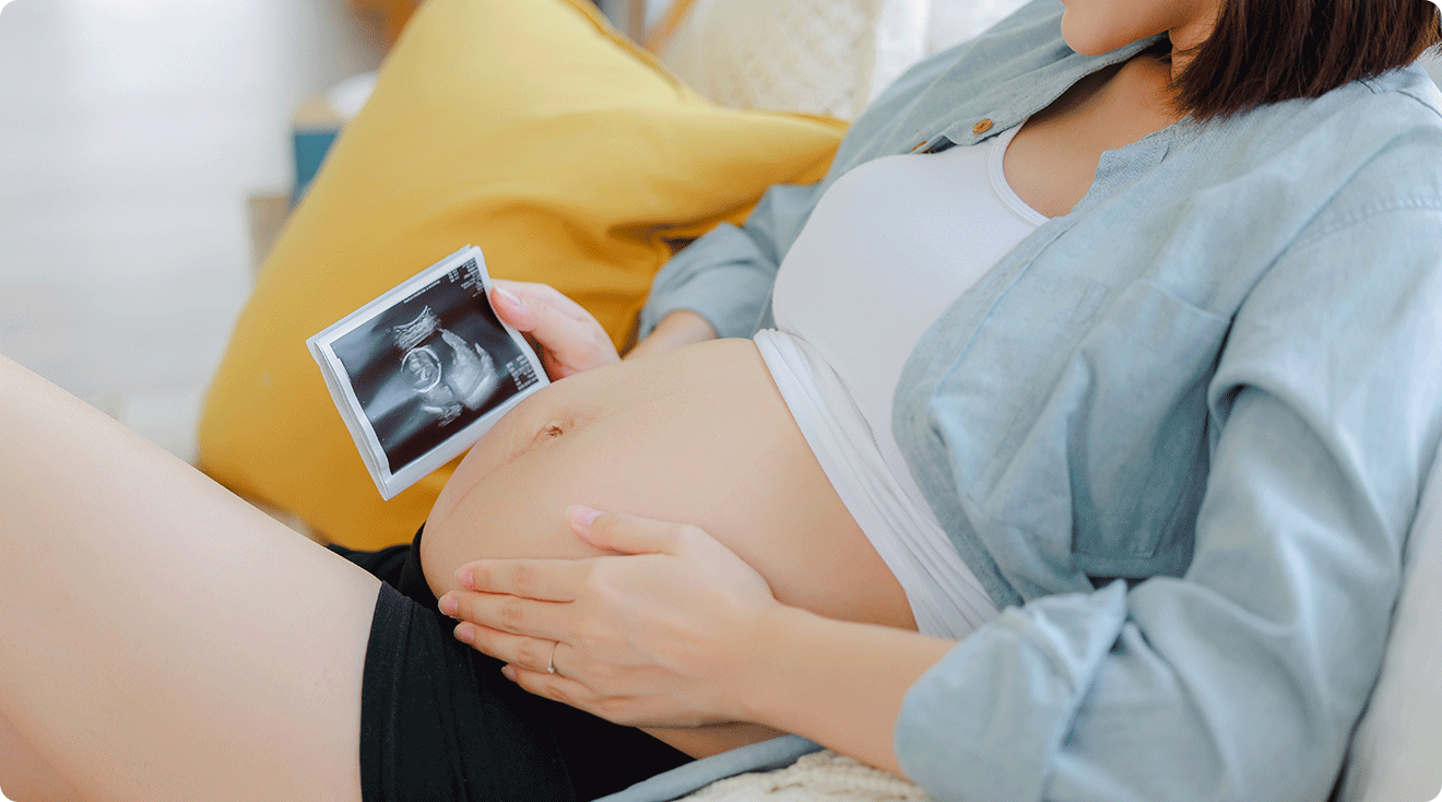 pregnant woman looking at ultrasound image