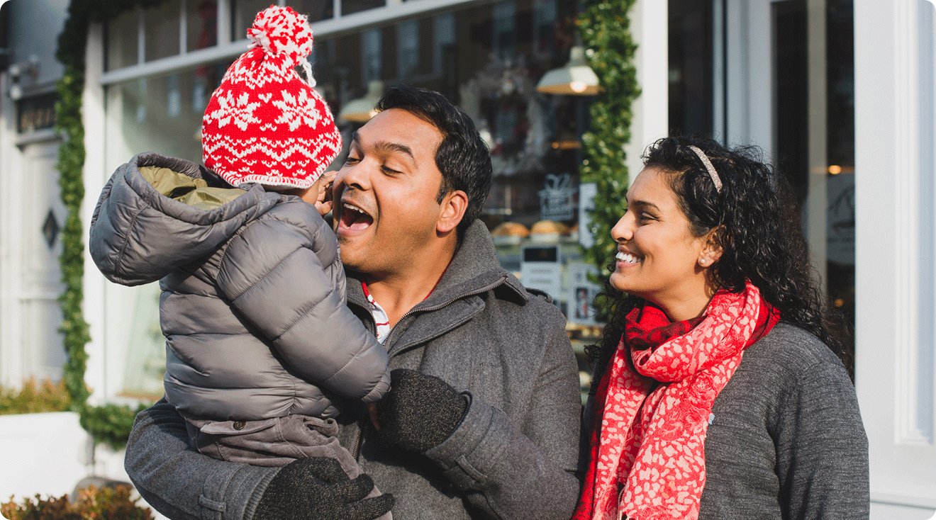 mom and dad outside with baby during the winter