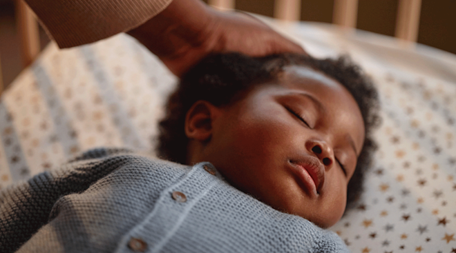 close up of baby sleeping in crib
