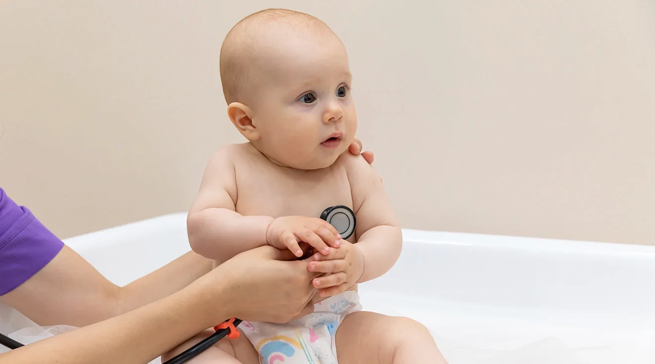 9 month old baby being examined by doctor