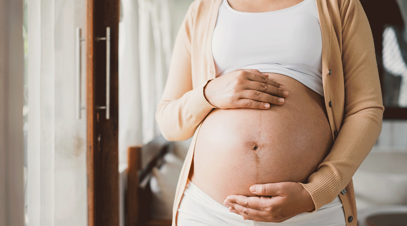 close up of pregnant belly at home