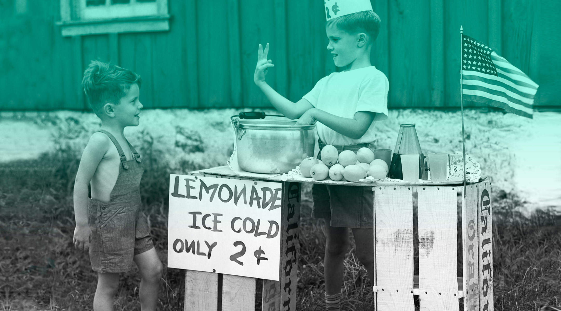 little boy buying lemonade from a stand