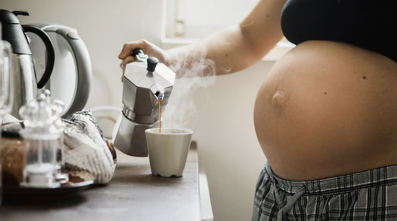 pregnant woman pouring a cup of coffee in the morning at home